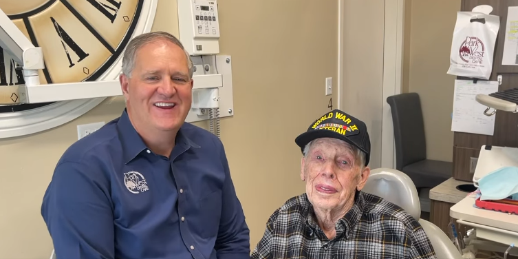 100-year-old World War II veteran smiling at the dental office, celebrating his milestone visit as one of our inspiring patients in Idaho Falls.